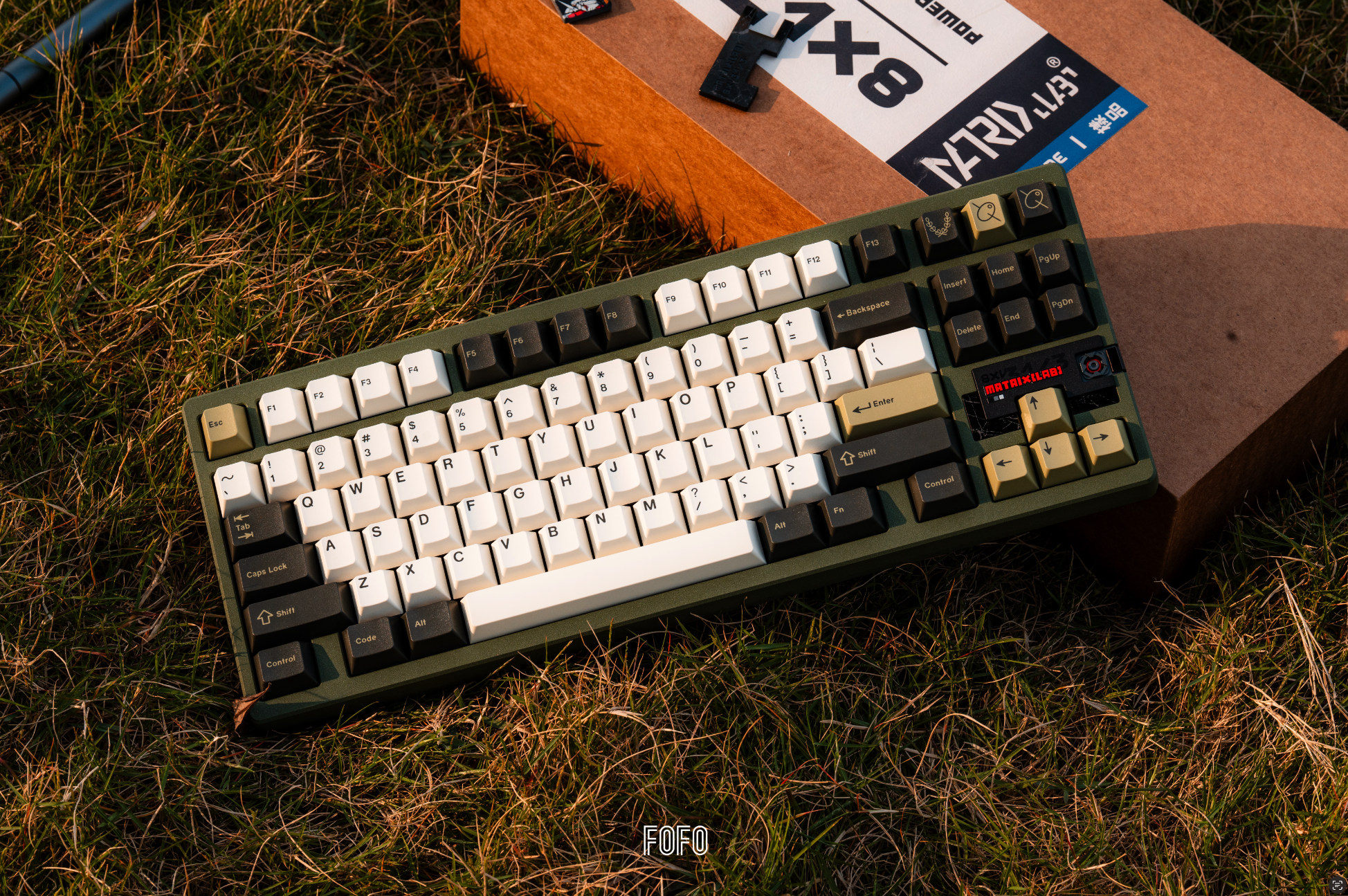 Matrix Lab 8XV 3 ⅓ tenkeyless keyboard photographed in olive with contrasting keycaps